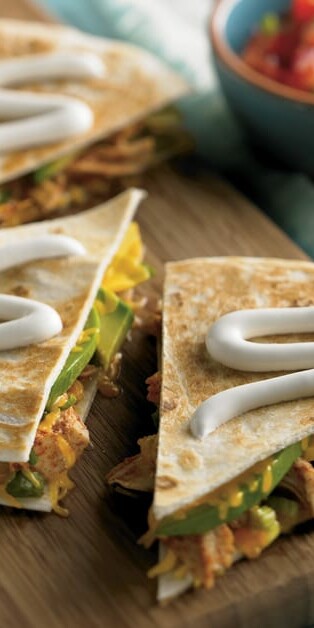 Chicken Avocado Quesadilla with sour cream on top
