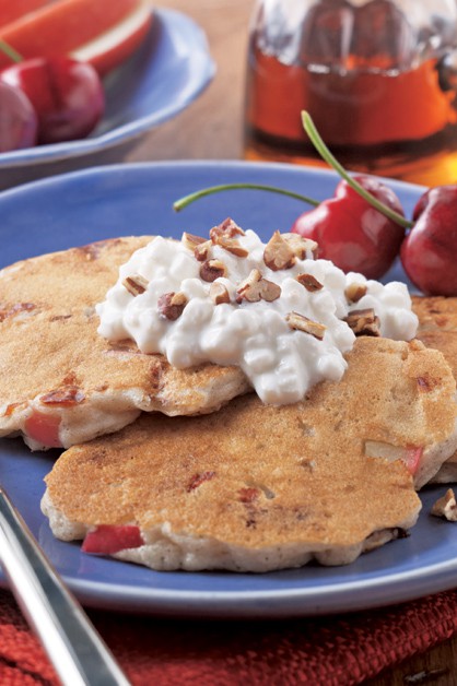 stack on cinnamon apple pancakes on a plate with cottage cheese