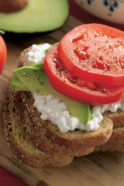 Open Faced Hearty Wheat Sandwich with bread sliced, cottage cheese, avocado, and tomato