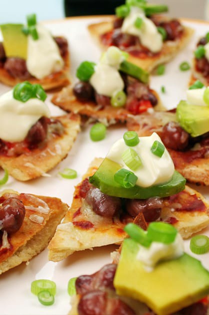 tex mex pita nachos on plate with avocados and sour cream