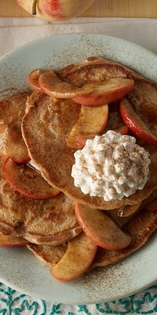 stack of cinnamon apple pancakes with cottage cheese and apples on top