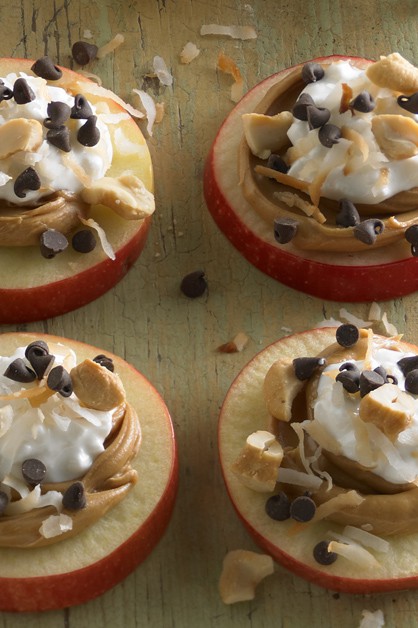 apple slices with peanut butter, cottage cheese, chocolate chips, and nuts on top