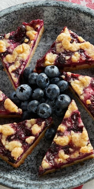 Blueberry Pie Bars on a plate with blueberries