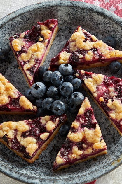 Blueberry Pie Bars on a plate with blueberries