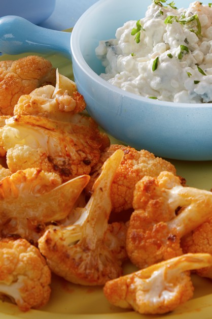 buffalo roasted cauliflower on plate with a side of cottage cheese