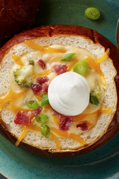 Cheese Beer Soup in bread bowl with sour cream on top