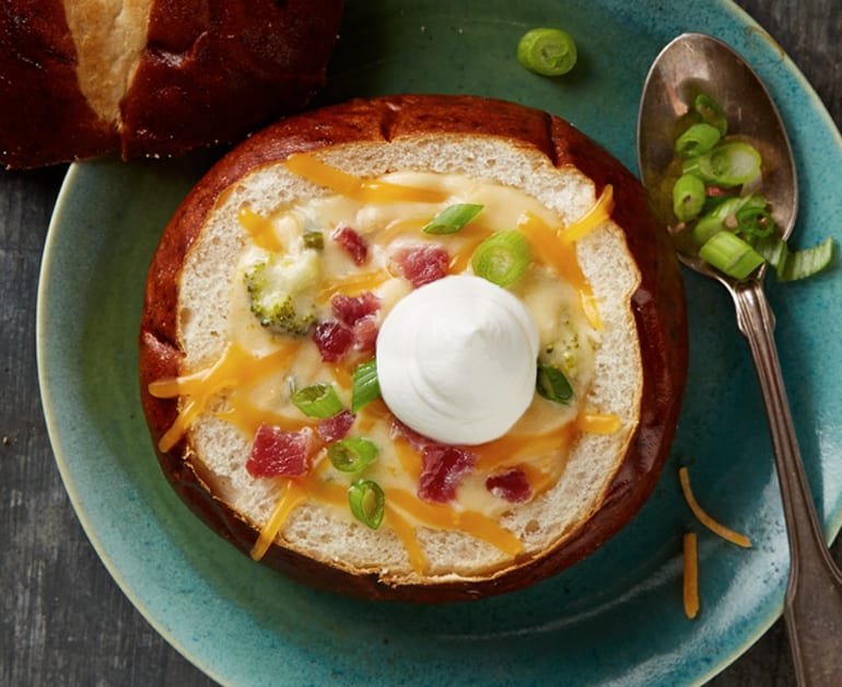 Cheese Beer Soup in bread bowl with sour cream on top