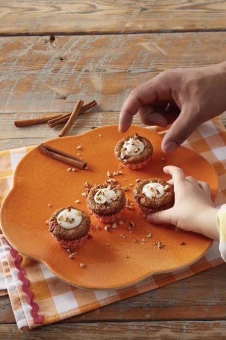 Carrot Cake Cookie Cup on plate with people reaching for one