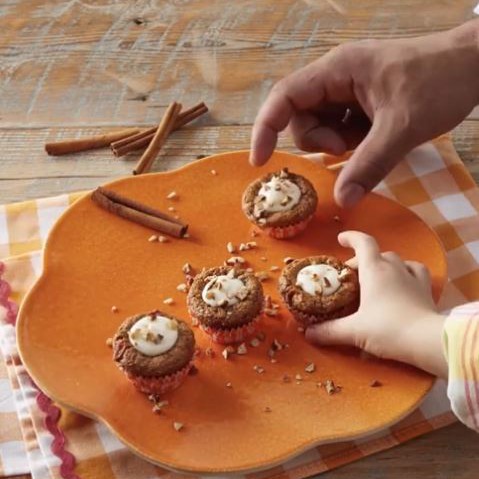 Carrot Cake Cookie Cup on plate with people reaching for one